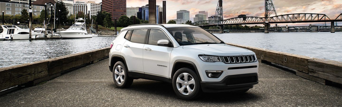 The 2021 White  Jeep Compass parked on an overpass.